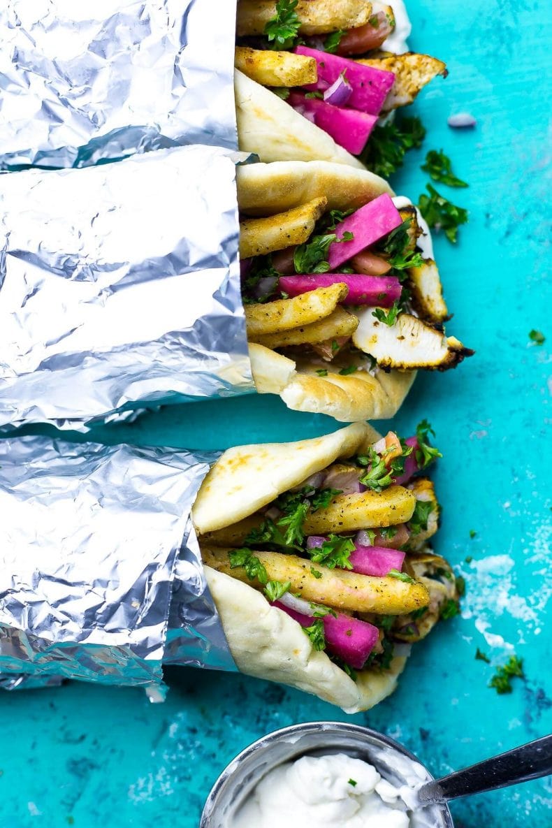 This Chicken Shawarma recipe comes complete with taboule, homemade vegan garlic sauce and pickled turnips all stuffed into a warm pita. It's a surprisingly healthy copy cat!