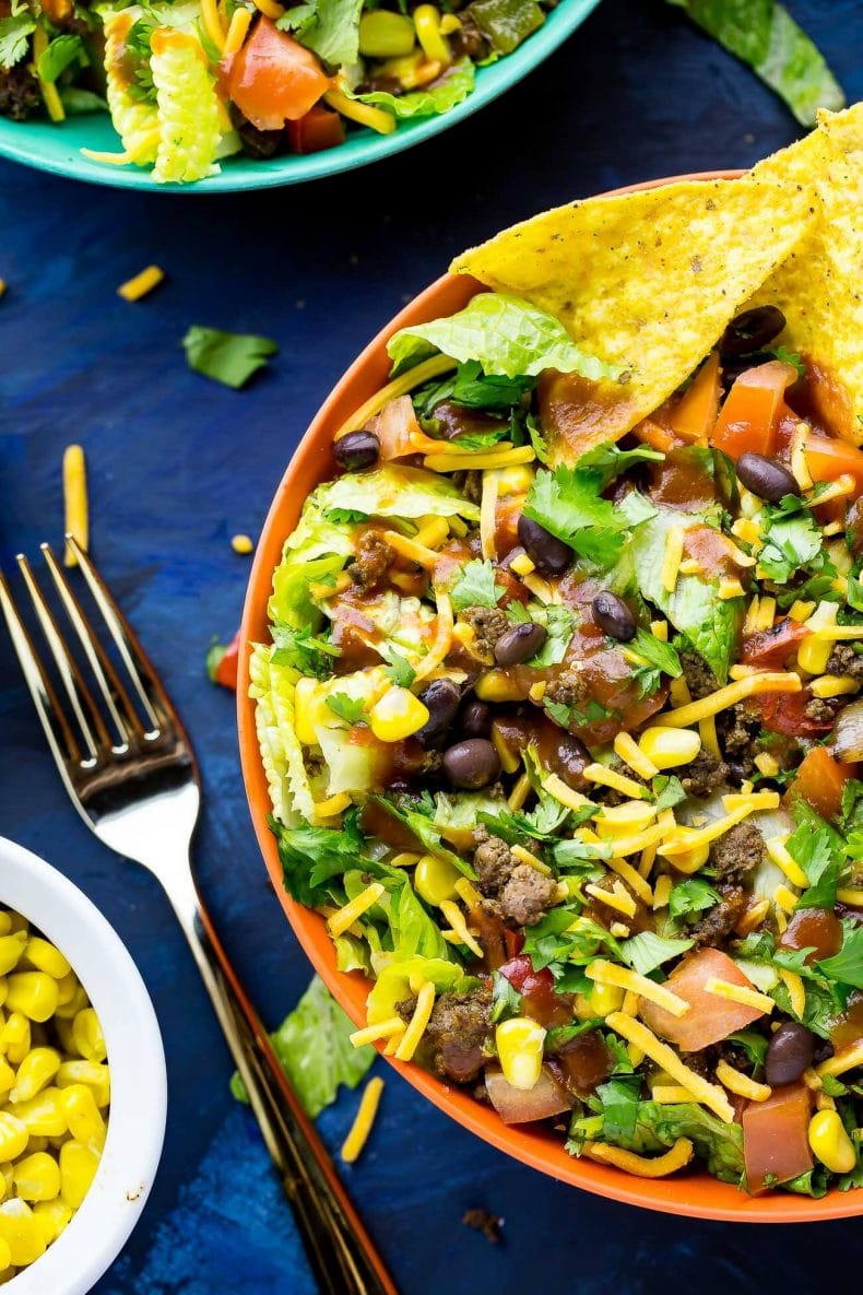 This Doritos Taco Salad is a delicious 20-minute dinner filled with fresh veggies and Cool Ranch Doritos, then topped with cheese, cilantro and taco sauce!