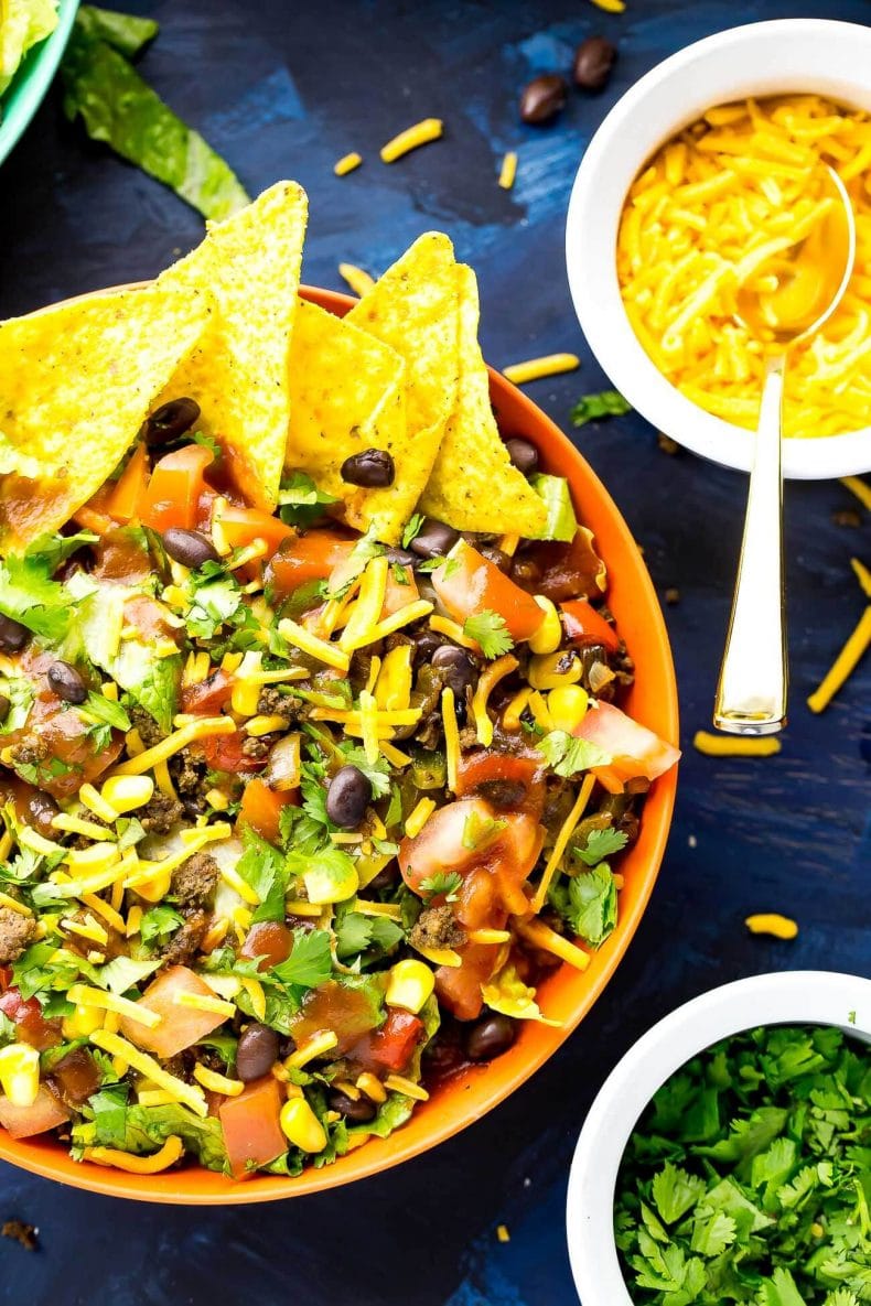 This Doritos Taco Salad is a delicious 20-minute dinner filled with fresh veggies and Cool Ranch Doritos, then topped with cheese, cilantro and taco sauce!
