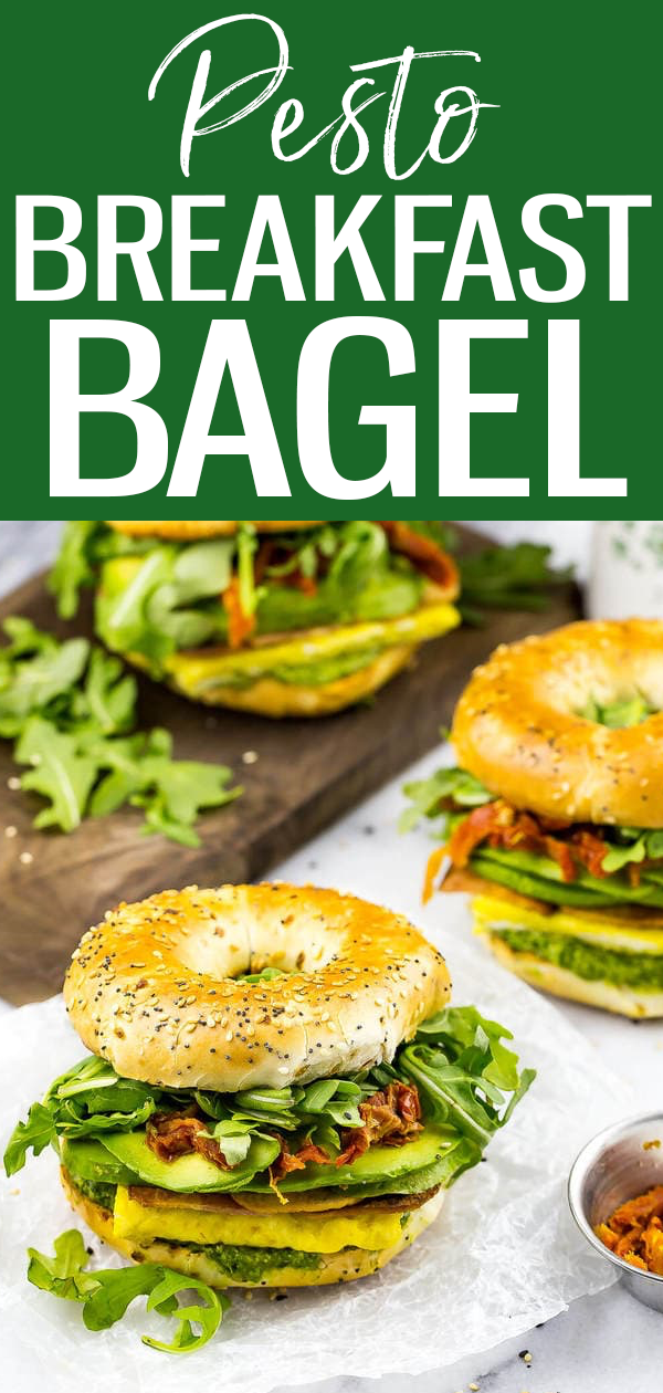 These Pesto Bagel Breakfast Sandwiches are loaded with eggs, bacon, arugula, sundried tomatoes, avocado and pesto in an everything bagel! #breakfastbagel #pestobagel