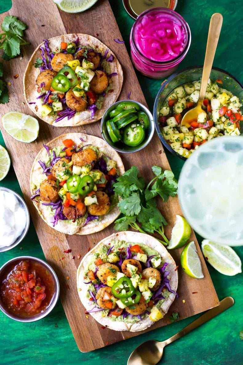 These spicy Seared Scallop Tacos with a savoury cilantro-filled Pineapple Salsa and served on corn tortillas are the perfect party food for Cinco de Mayo - with a twist!