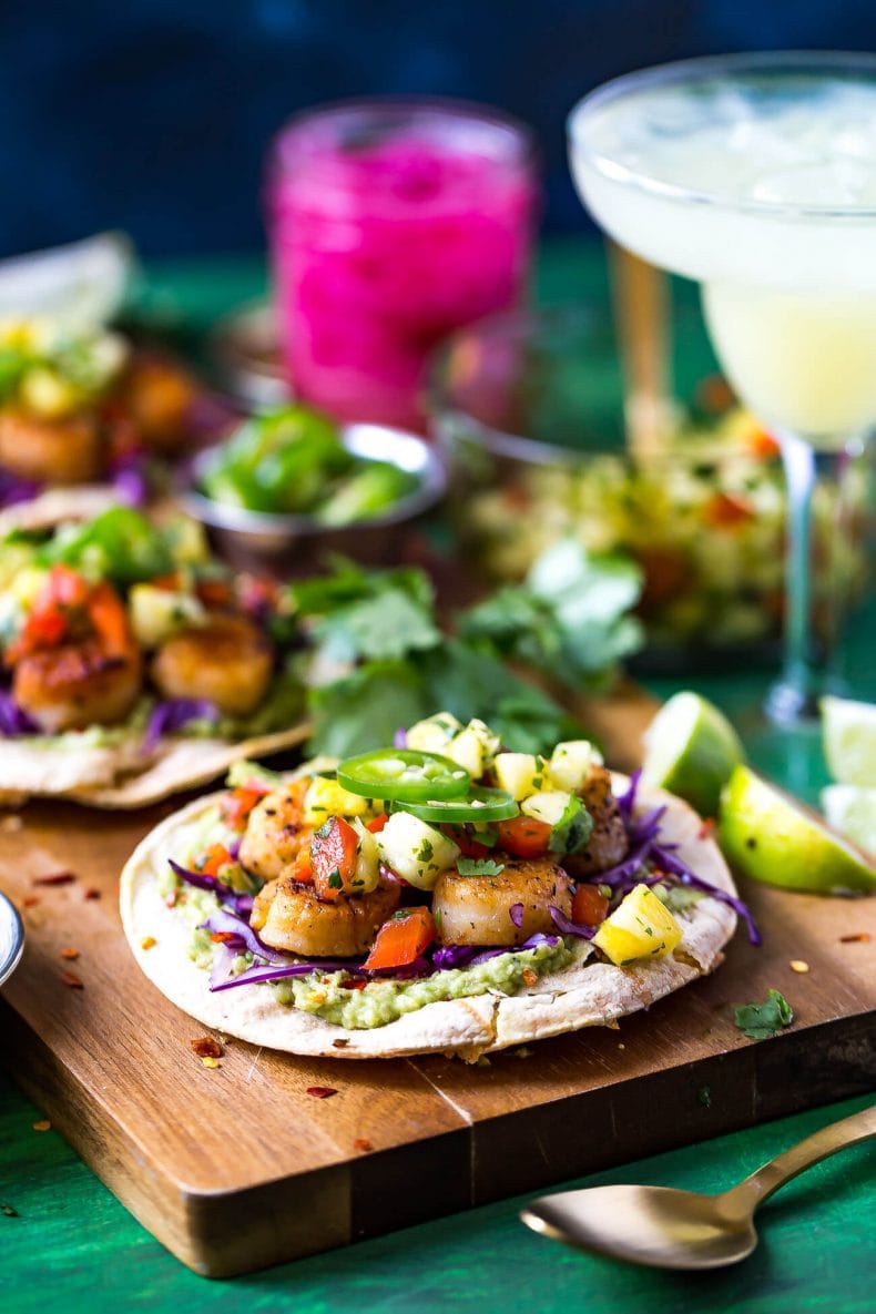 These spicy Seared Scallop Tacos with a savoury cilantro-filled Pineapple Salsa and served on corn tortillas are the perfect party food for Cinco de Mayo - with a twist!
