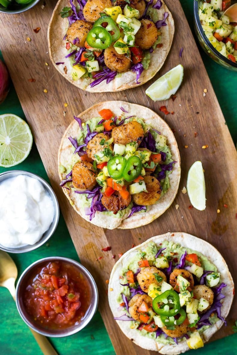 These spicy Seared Scallop Tacos with a savoury cilantro-filled Pineapple Salsa and served on corn tortillas are the perfect party food for Cinco de Mayo - with a twist!