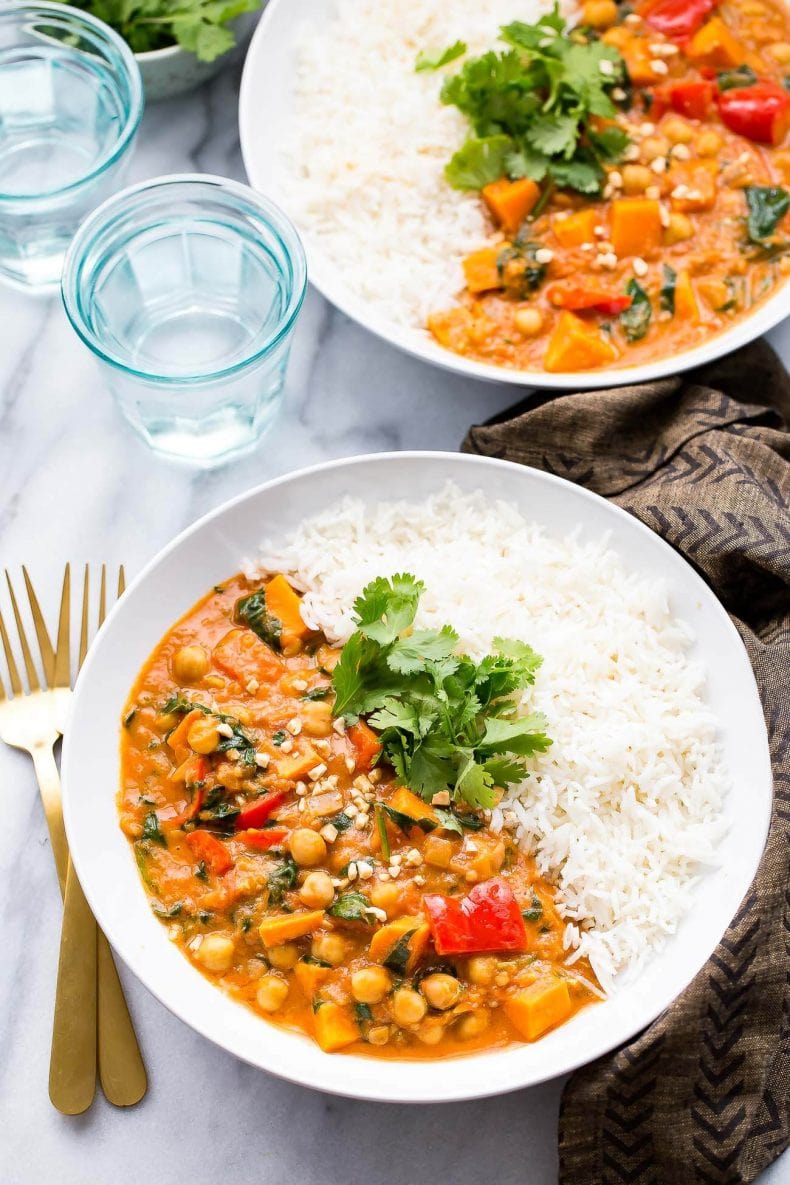 This Slow Cooker African-Inspired Peanut Stew is a hearty, savoury chickpea and sweet potato curry, served with basmati rice and topped with cilantro. It's also gluten-free and vegan!