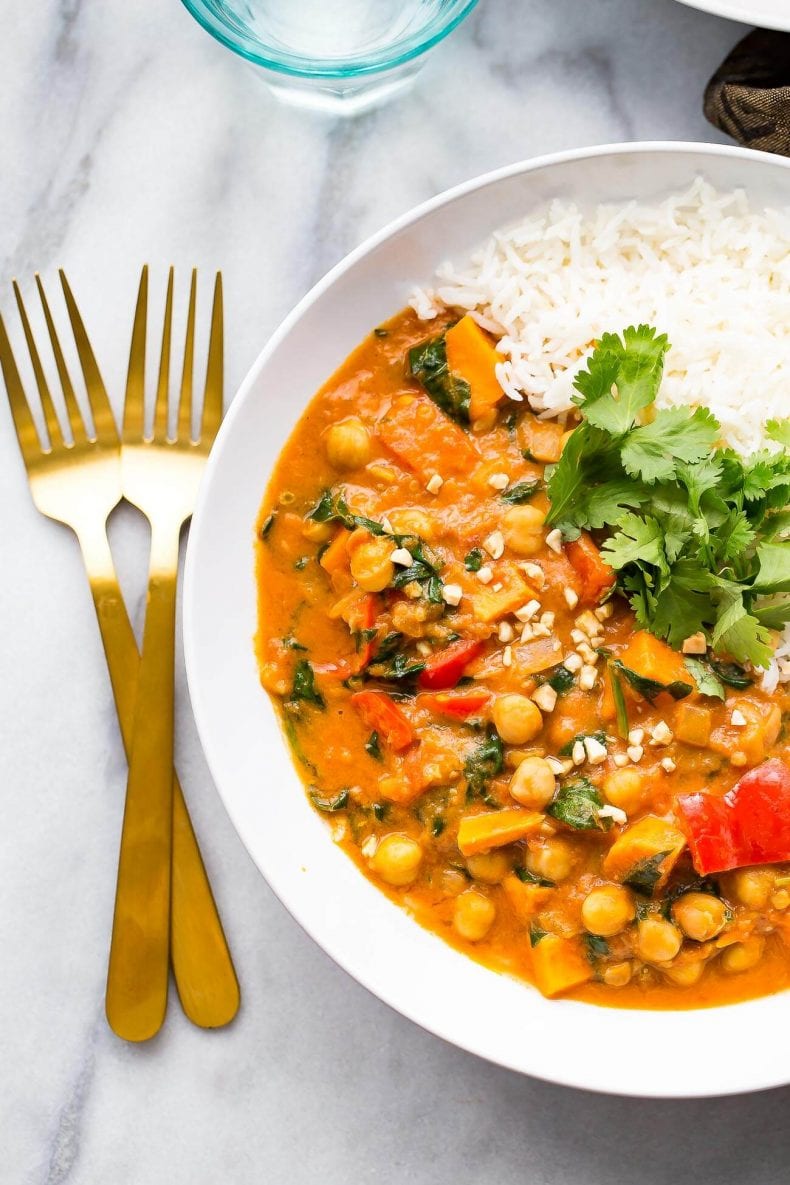 This Slow Cooker African-Inspired Peanut Stew is a hearty, savoury chickpea and sweet potato curry, served with basmati rice and topped with cilantro. It's also gluten-free and vegan!