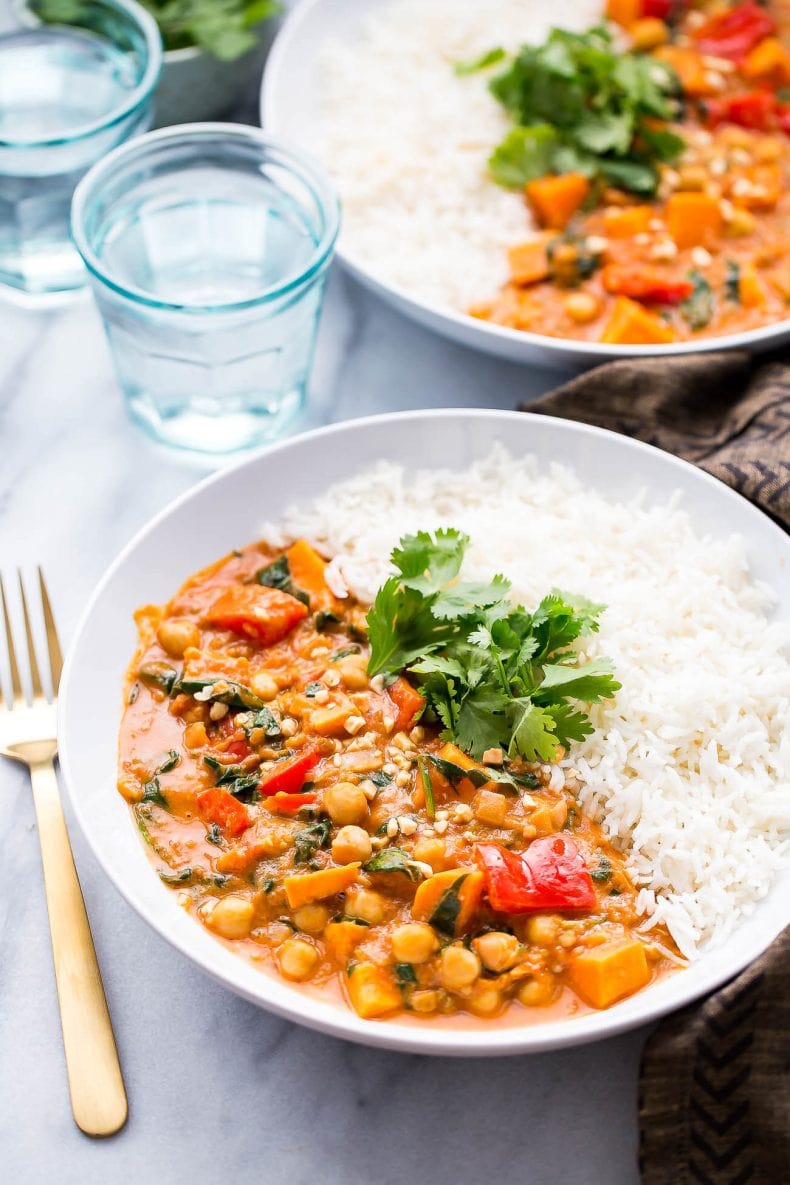 This Slow Cooker African-Inspired Peanut Stew is a hearty, savoury chickpea and sweet potato curry, served with basmati rice and topped with cilantro. It's also gluten-free and vegan!
