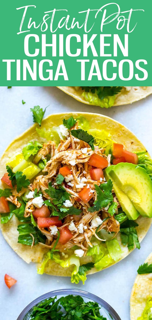 These Instant Pot Chicken Tinga Tacos are Mexican inspired - made with fire-roasted tomatoes & chipotle, they're gluten-free and ready in 30 minutes! #chickentinga #instantpot