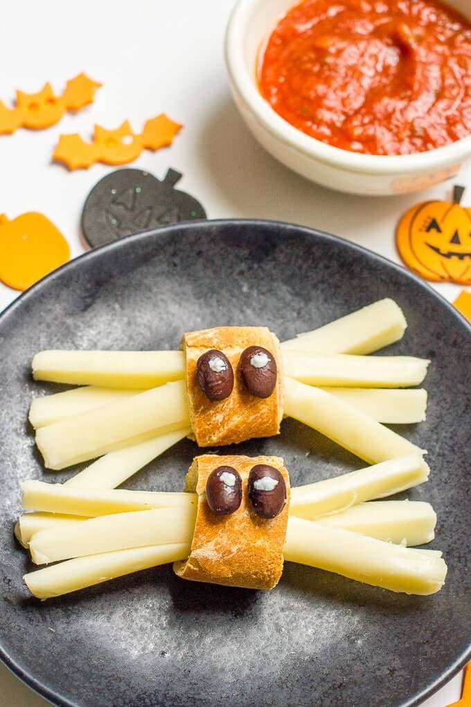 healthy Halloween spider snacks on a gray plate