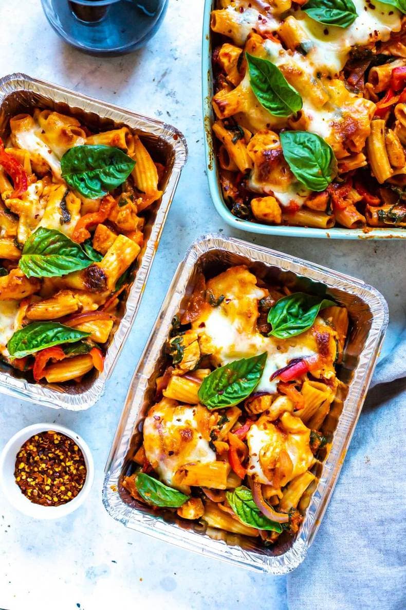 Two portions of Chicken Pasta Bake in freezer-friendly aluminium containers.