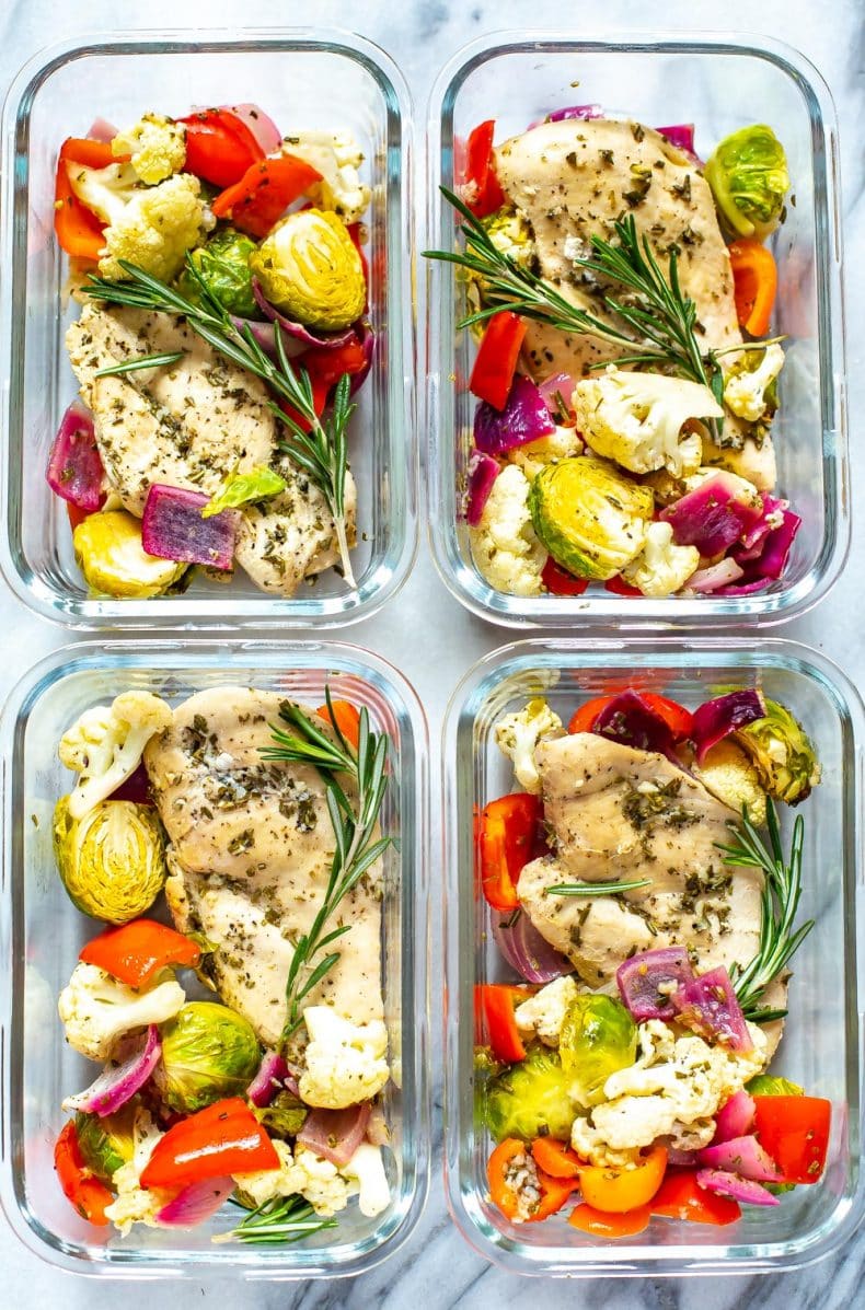 4 meal prep containers of healthy rosemary chicken and vegetables