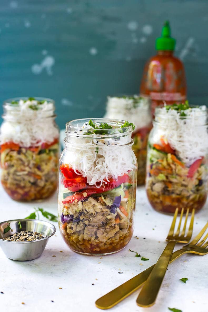 Three chicken spring roll jars in the background with one chicken spring roll jar in the foreground.