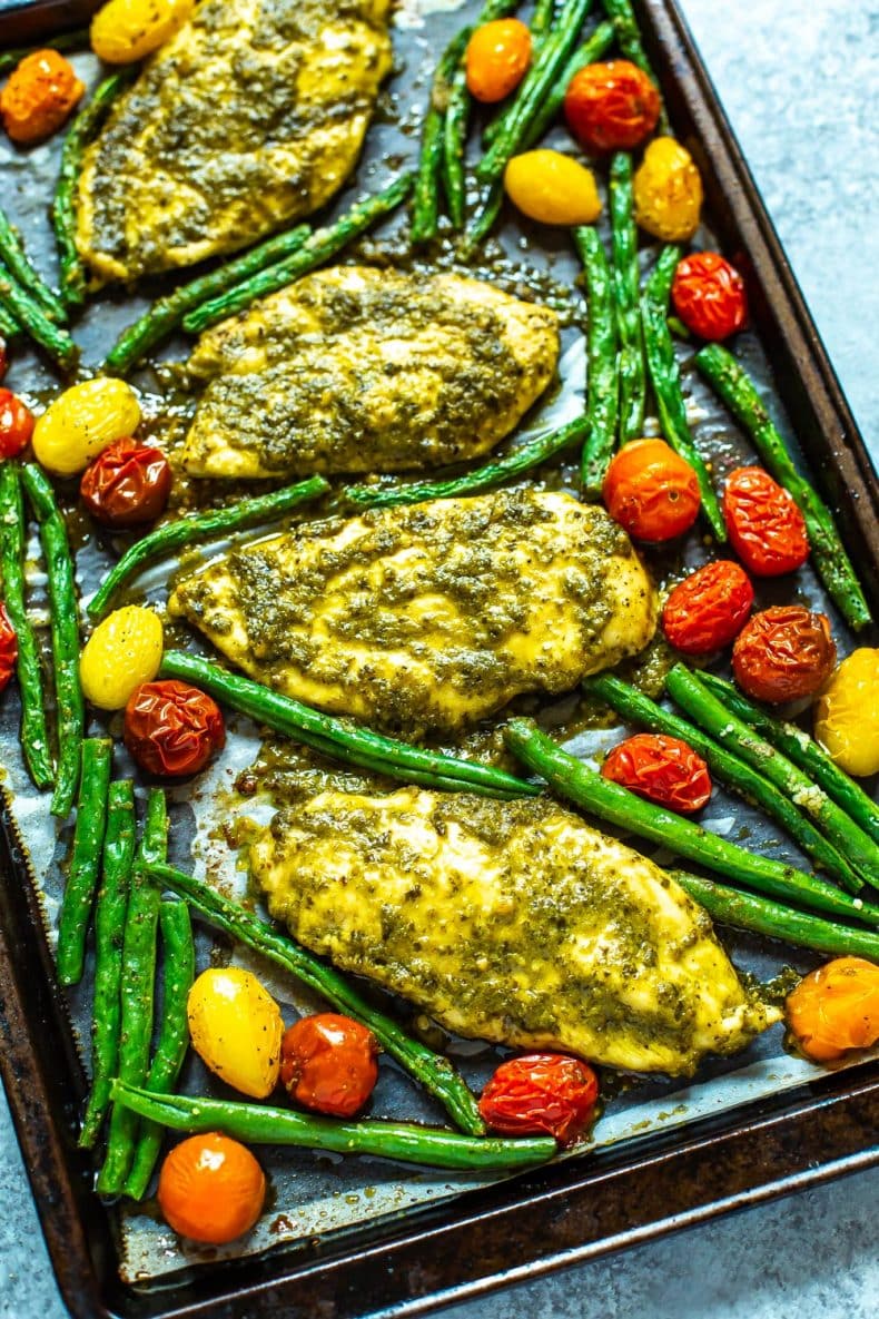 pesto chicken dinner with roasted asparagus and cherry tomatoes