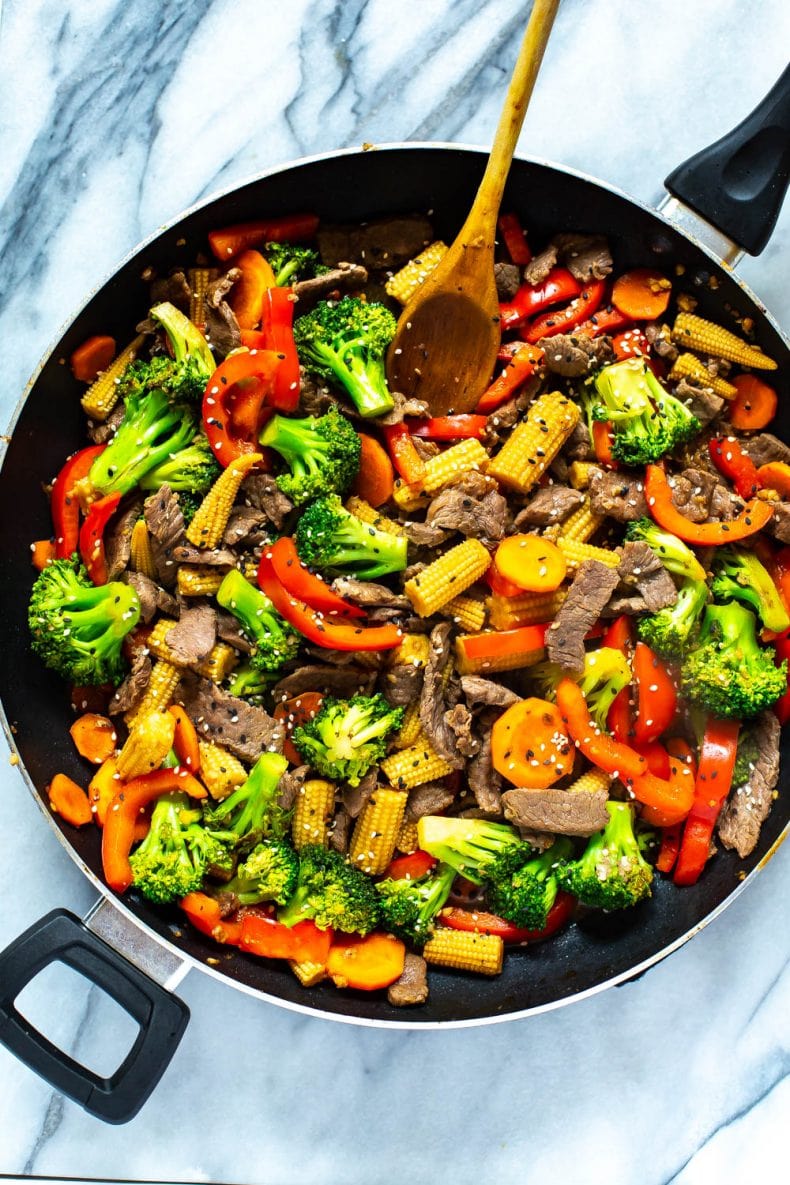 wooden spoon stirring an easy beef stir fry dinner