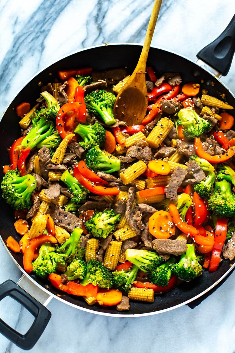 Beef stir fry in a black skillet.