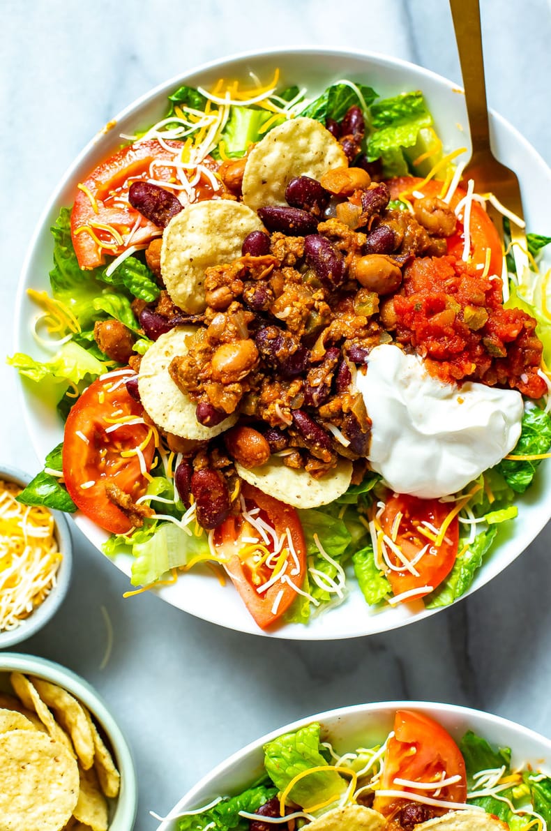 A close-up of a bowl of Copycat Wendy's Taco Salad with a fork in it.