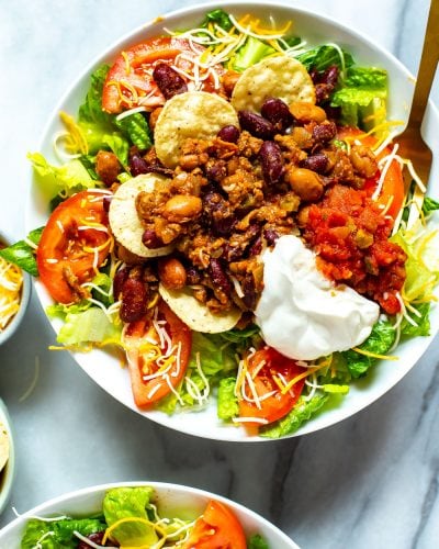 A close-up of a bowl of Copycat Wendy's Taco Salad with a fork in it.
