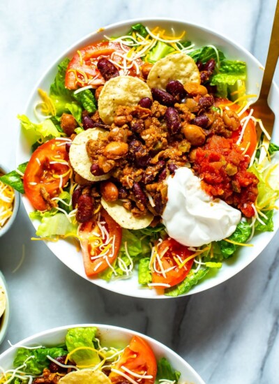 A close-up of a bowl of Copycat Wendy's Taco Salad with a fork in it.