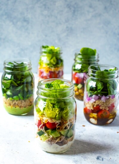 A close-up of the ranch mason jar salad, with the other mason jar salads in the background.