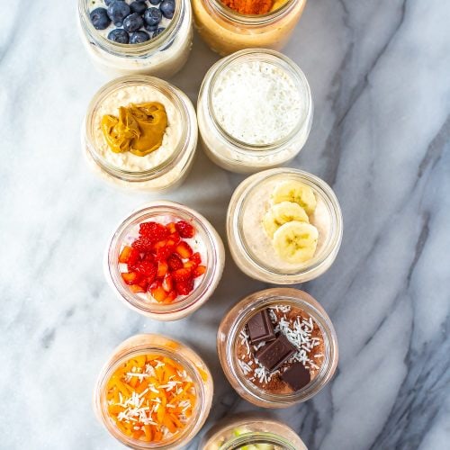 9 mason jars shown from above, each with filled with a different flavour of overnight oats.