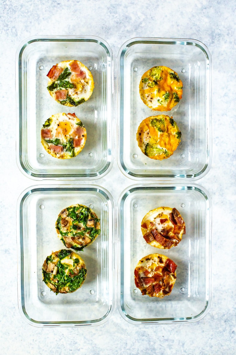 Two rows of two meal prep containers, each containing a different pair of baked eggs.
