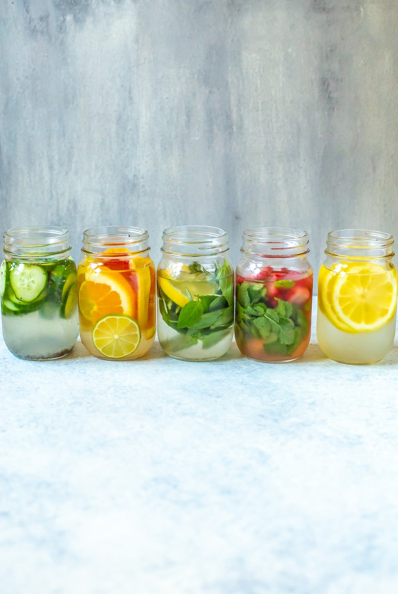 5 lemon water varieties lined up against a backdrop
