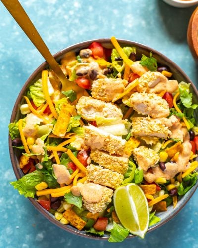A close-up of a bowl of Copycat McDonald's Southwest Salad with a fork in it.