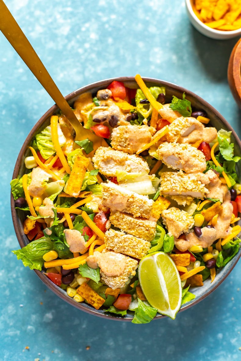 A close-up of a bowl of Copycat McDonald's Southwest Salad with a fork in it.