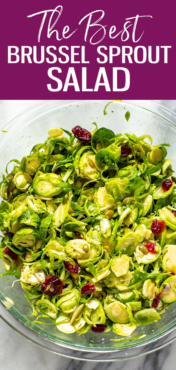 This is the BEST Brussels Sprouts Salad, with an easy apple cider vinegar and honey dijon dressing. Toss with dried cranberries and pumpkin seeds for a festive fall slaw! #brusselssprouts #slaw #salad #fallrecipes