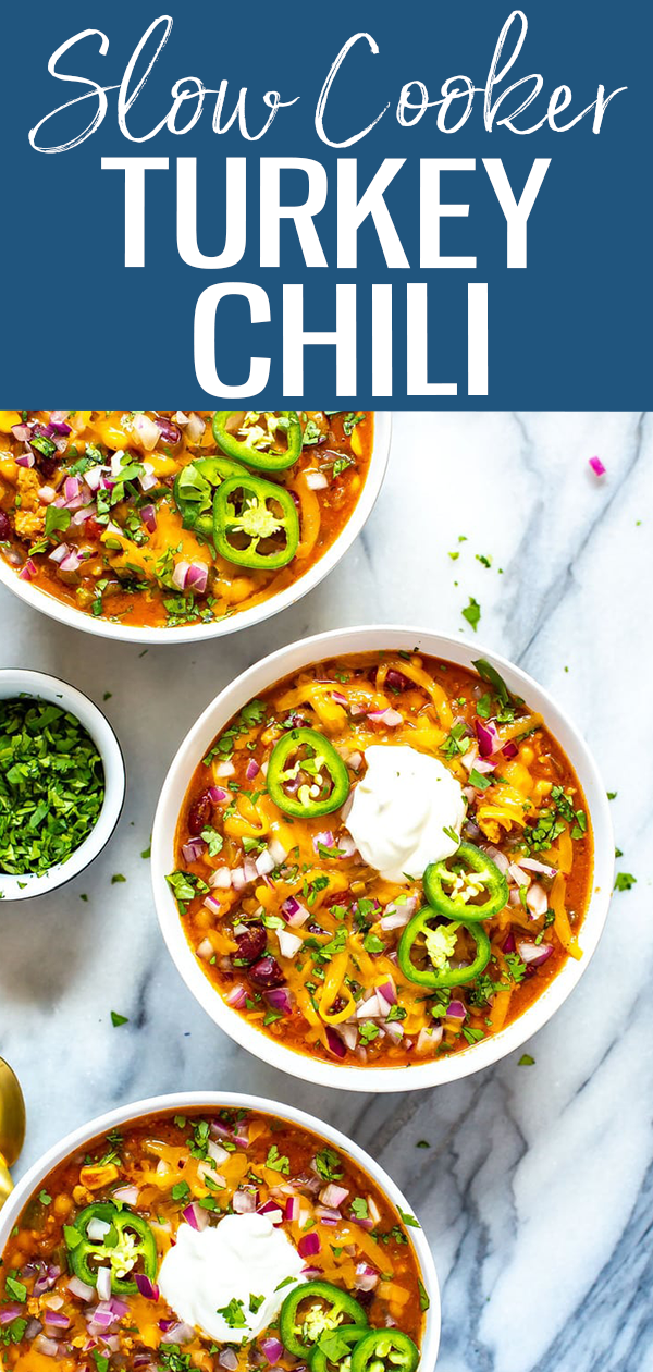 This Slow Cooker Turkey Chili is the most healthy, flavourful chili you'll ever make! It's filled with beans, veggies and ground turkey, then loaded up with toppings. You won't miss the beef!  #turkeychili #slowcooker