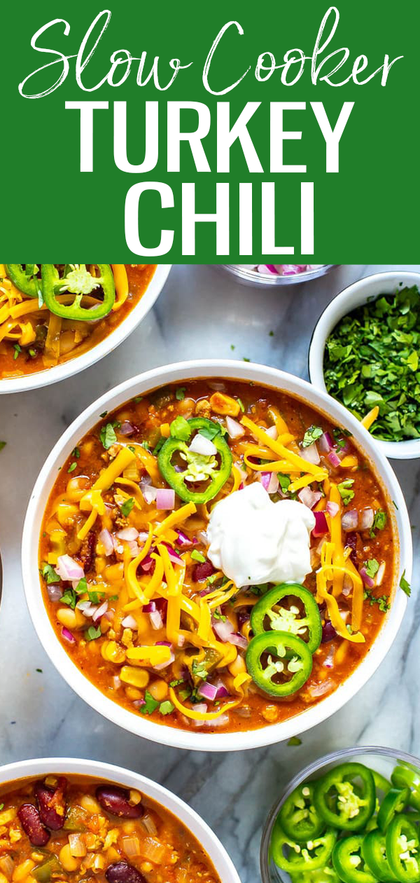 This Slow Cooker Turkey Chili is the most healthy, flavourful chili you'll ever make! It's filled with beans, veggies and ground turkey, then loaded up with toppings. You won't miss the beef!  #turkeychili #slowcooker