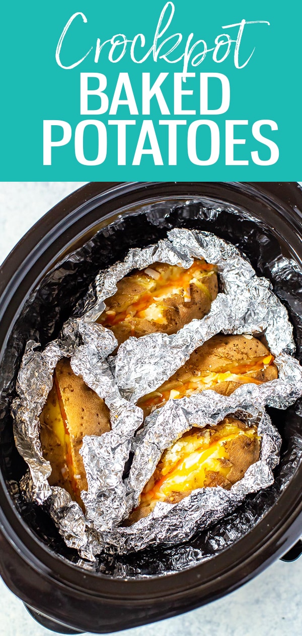 These Crock Pot Baked Potatoes are WAY easier to make than oven baked - load them up with bacon, cheese, sour cream and chives for a full meal! #crockpot #bakedpotatoes #slowcooker