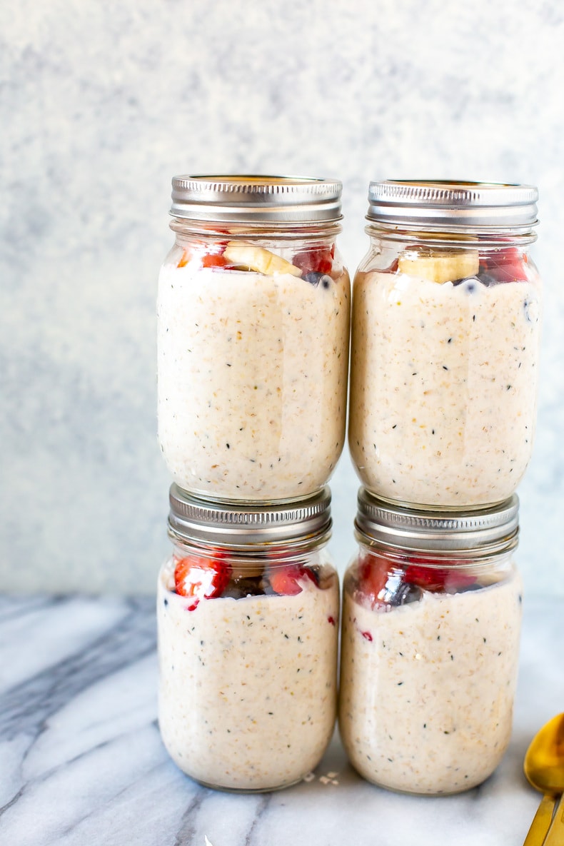 stacked jars of oatmeal with fresh fruit on top