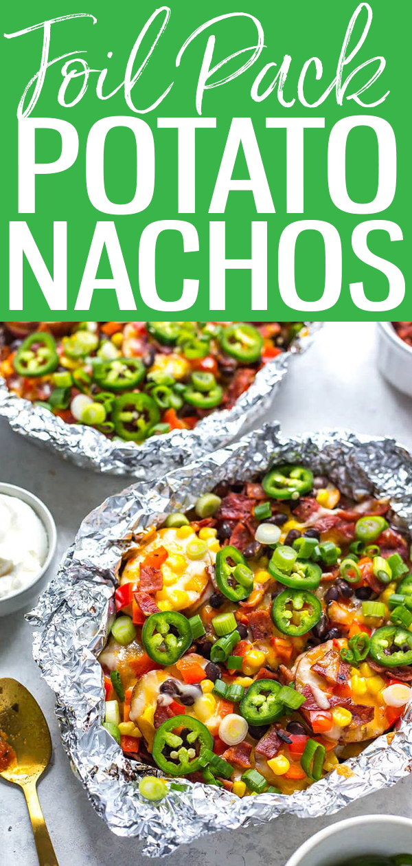 These Cheesy Grilled Potatoes in Foil are like potato nachos made easy on the BBQ! Slice potatoes, then top with cheese, bacon & veggies. #foilpack #potatonachos