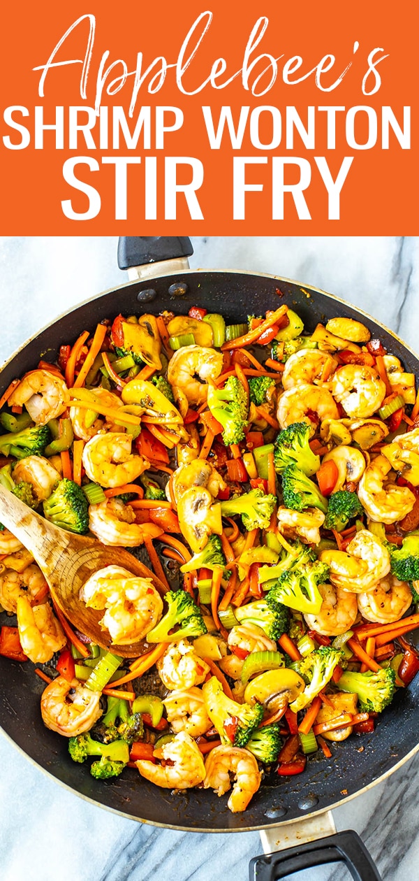 This Shrimp Wonton Stir Fry is an Applebee's copycat filled with veggies tossed in a sweet and spicy sauce, served over rice & topped with wonton strips. #applebees #shrimpwontonstirfry