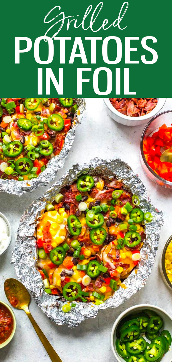 These Cheesy Grilled Foil Potatoes are potato nachos made easy on the BBQ. Just slice the potatoes, add on your toppings and grill! #foilpack #grilledpotatoes