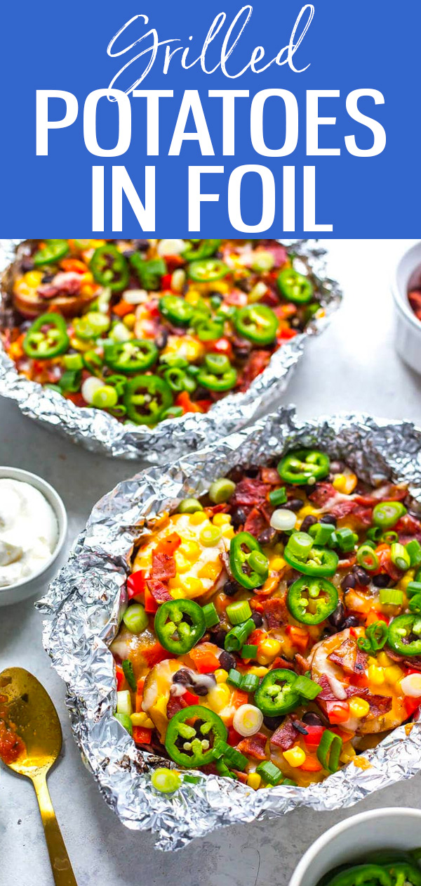 These Cheesy Grilled Foil Potatoes are potato nachos made easy on the BBQ. Just slice the potatoes, add on your toppings and grill! #foilpack #grilledpotatoes
