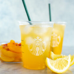Two cups of copycat Starbucks iced peach green tea lemonade.