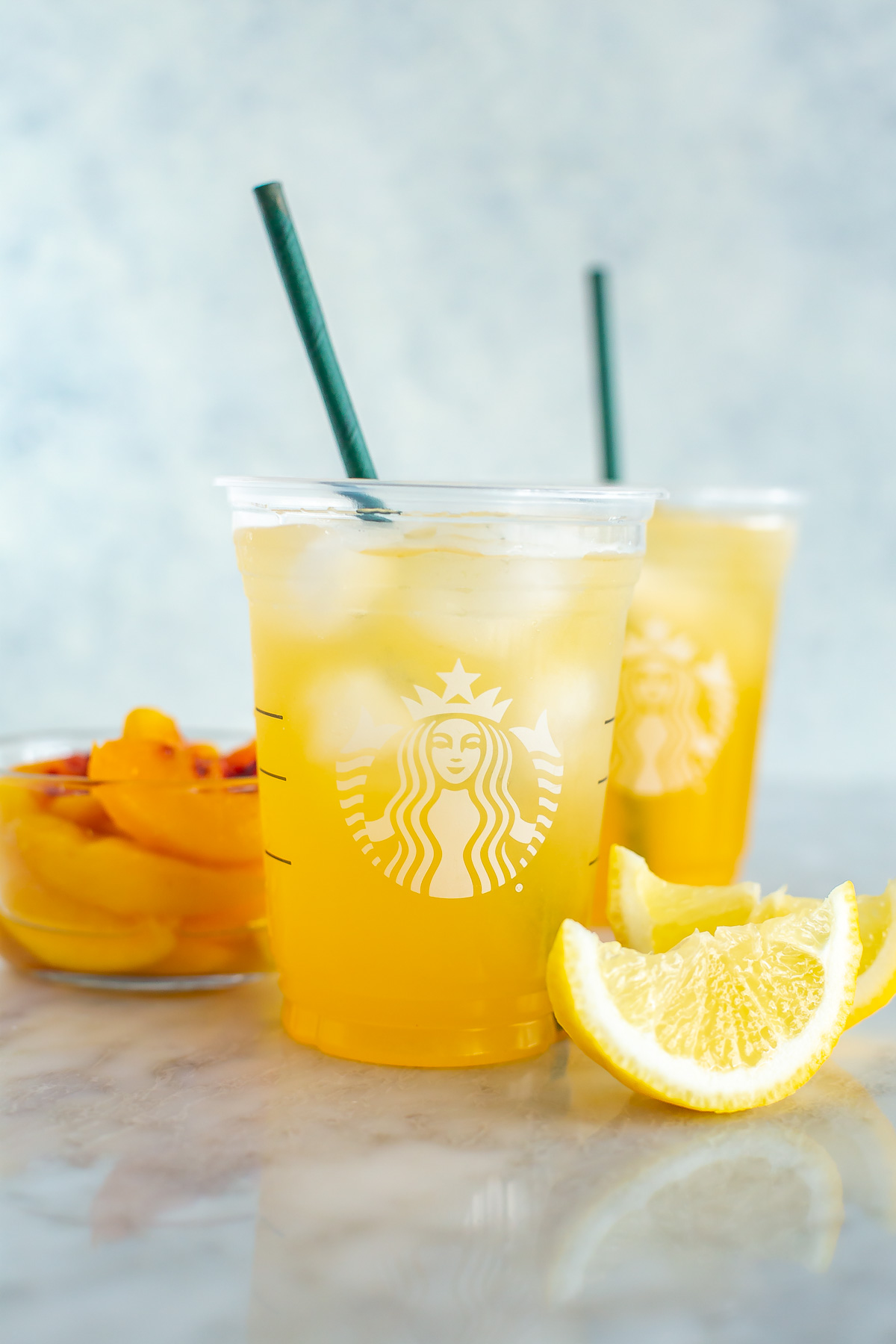 Two cups of copycat Starbucks iced peach green tea lemonade.