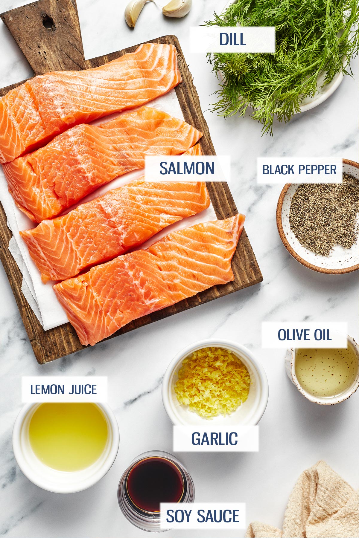 Ingredients for air fryer salmon: salmon, dill, black pepper, lemon juice, garlic, olive oil, and soy sauce.