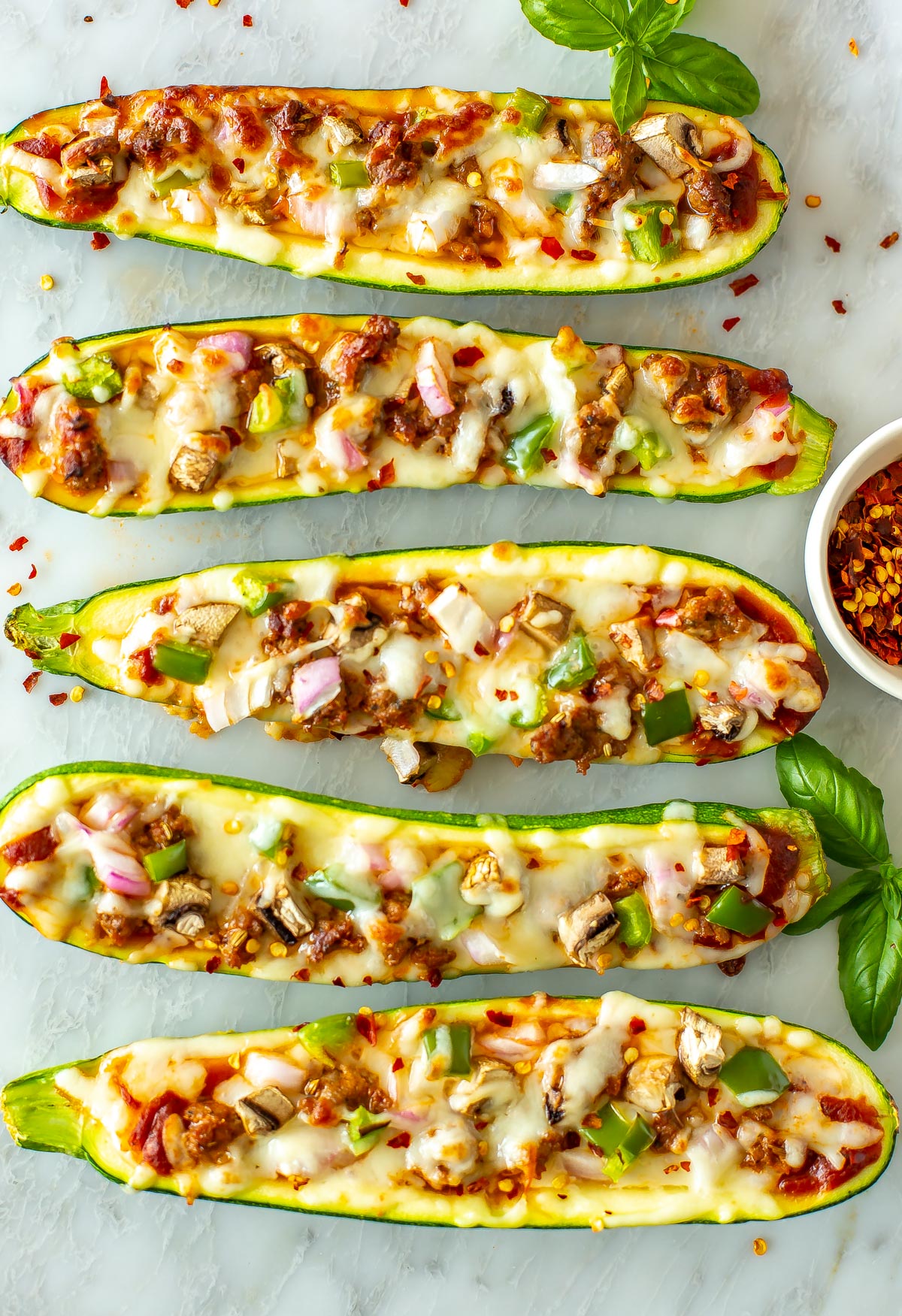 Zucchini pizza boats loaded with toppings.