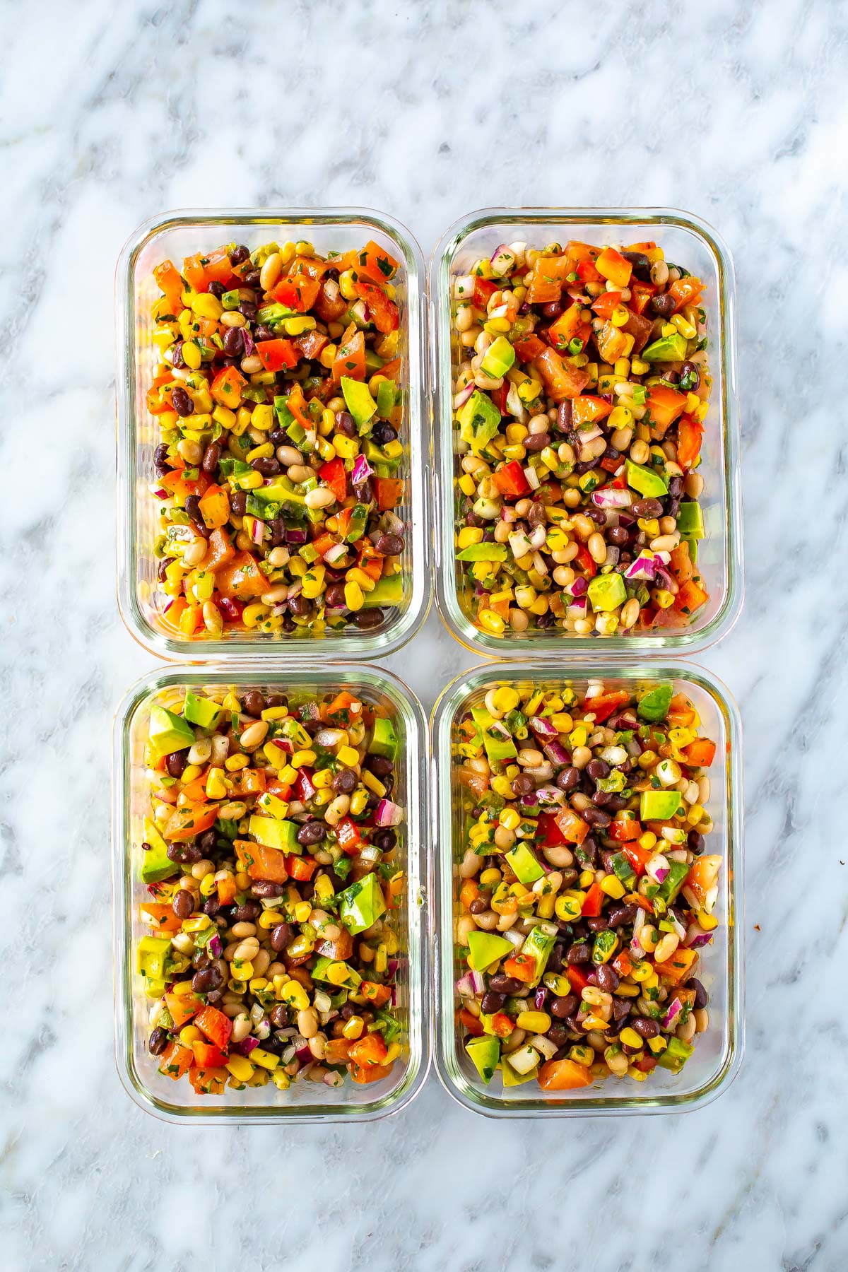 Four meal prep containers filled with cowboy caviar.