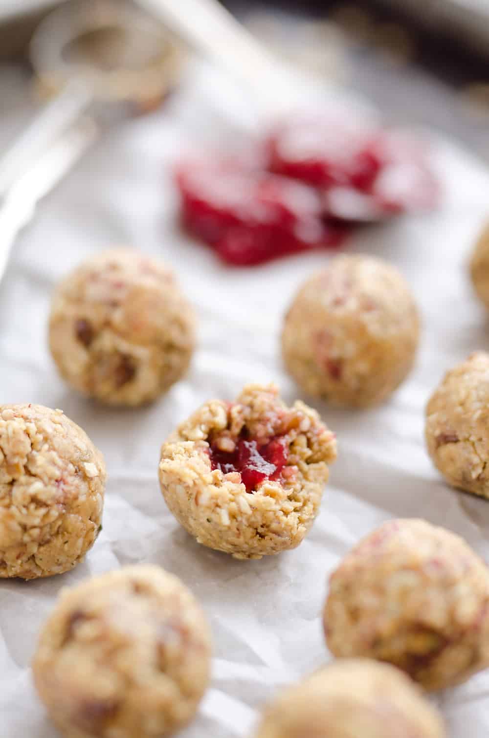 Peanut butter energy bites with strawberry jam on the inside