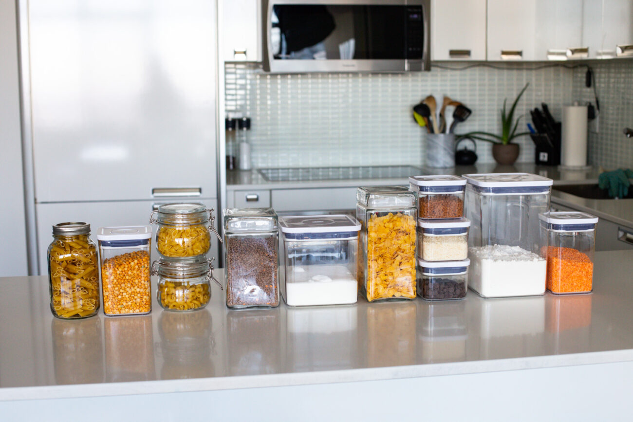 Several pantry staples in a counter organized in different containers.