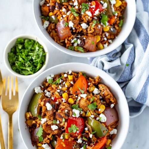 Overhead shot of two bowls of fiesta chicken and rice