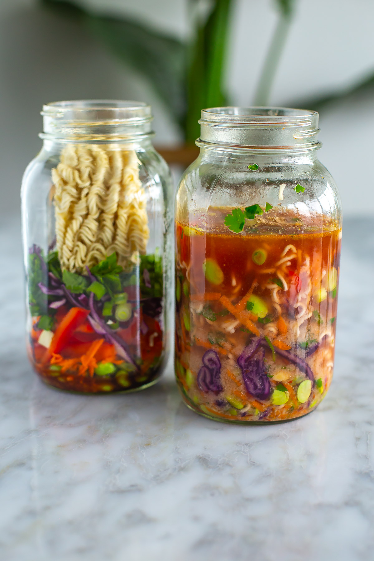 Two DIY instant noodle mason jars, one with water inside.