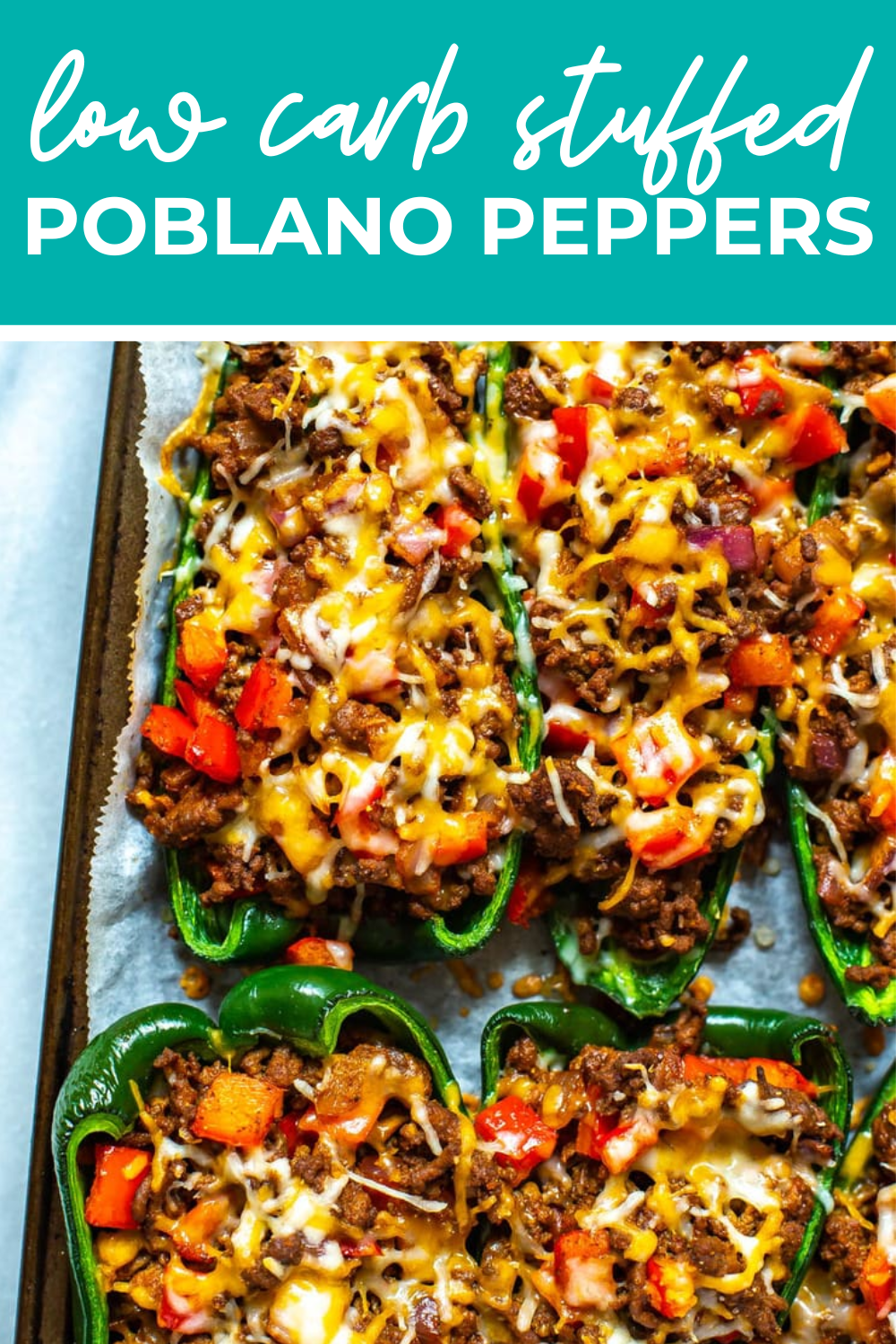 A close-up of stuffed poblano peppers on a sheet pan with the text "Low Carb Stuffed Poblano Peppers" on top.