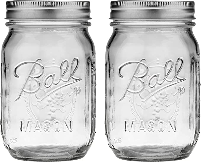 Two empty mason jars with lids on.