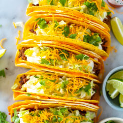 An overhead shot of five cheesy gordita crunch tacos.