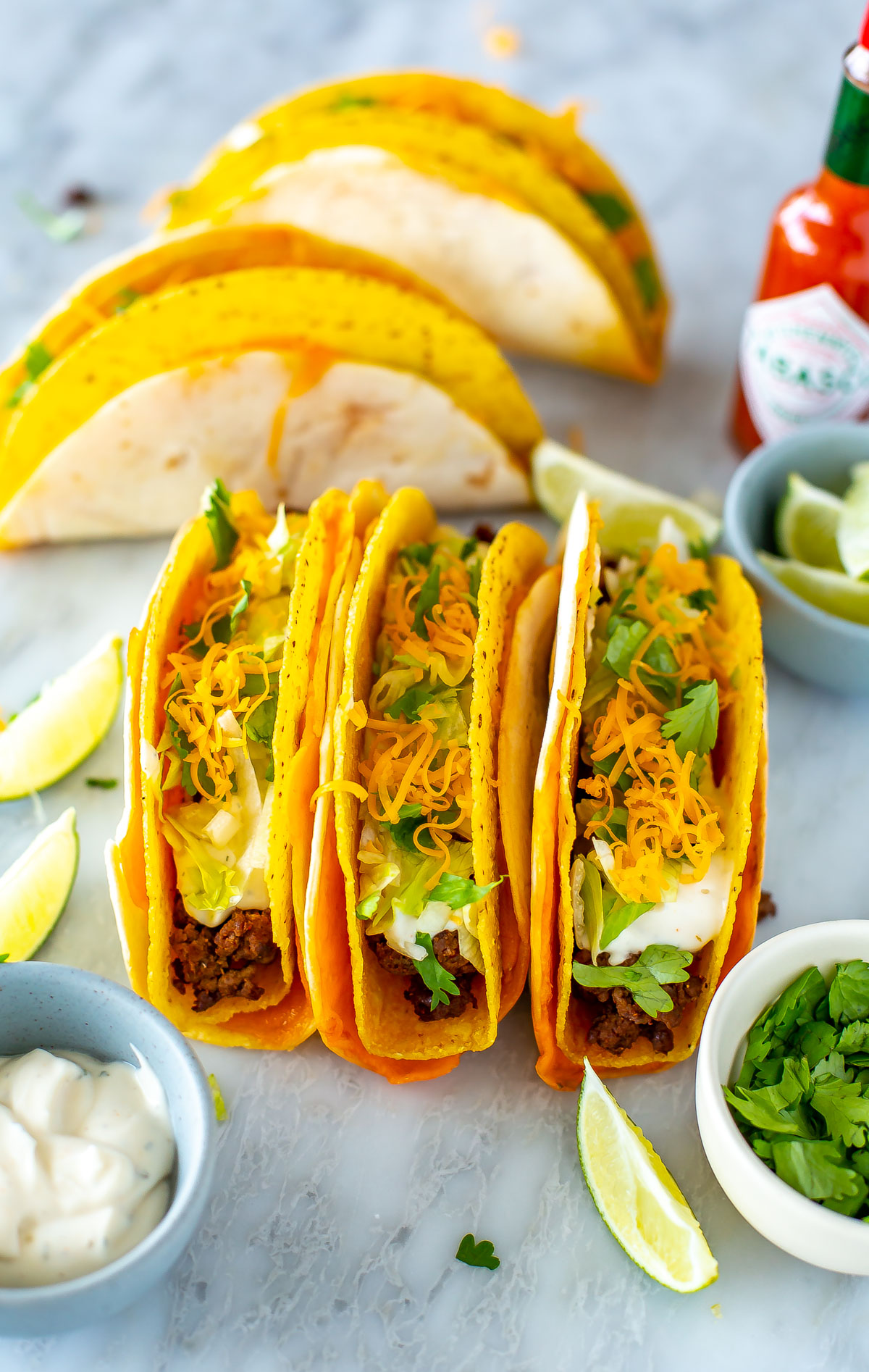 Three cheesy gordita crunch tacos placed side by side.