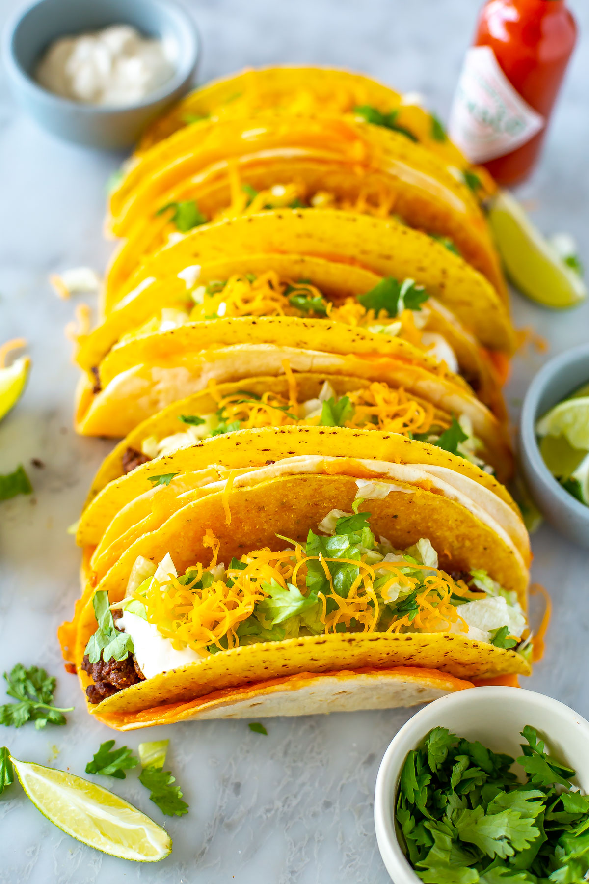 Several chessy gordita crunch tacos in a line.